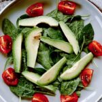 Ensalada de aguacate con tomates cherry y hojas verdes
